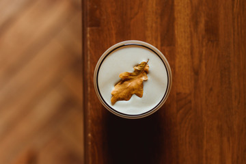 Hot spicy masala alcoholic drink, decorated with an autumn leaf