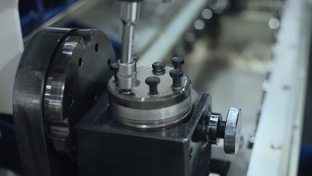 Manual worker assembling machine parts at production line