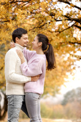 Fototapeta premium Couple in love in the autumn leaves