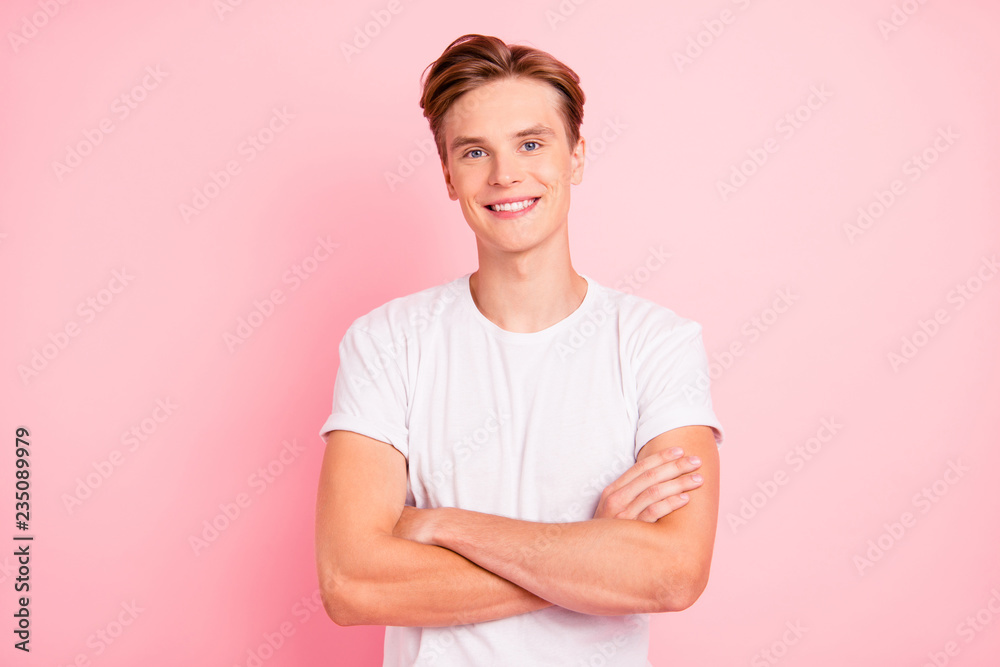 Wall mural photo of pretty man stand isolated on bright pink background wal