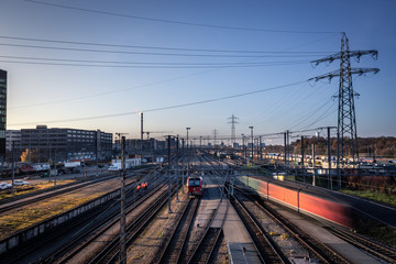Fototapeta na wymiar Industrial city railway tracks and moving trains