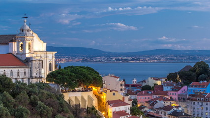 Lisbon after sunset aerial panorama view of city centre with red roofs at Autumn day to night timelapse, Portugal