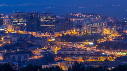 Panoramic View over Lisbon and Almada from a viewpoint in Monsanto night to day timelapse.