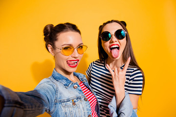 Carefree careless funny glad two girlish lady isolated on yellow