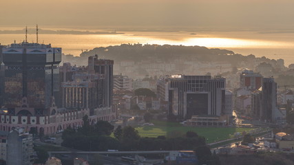 Panoramic view during sunrise over Lisbon and Almada from a viewpoint in Monsanto morning timelapse.