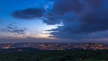 Panoramic View over Lisbon and Almada from a viewpoint in Monsanto night to day timelapse.