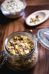 Glass jar with various seeds, oats and cereal.