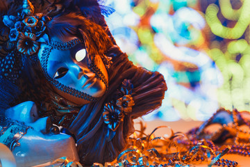 Fototapeta premium Traditional female carnival venetian mask on blue bokeh background. Masquerade, Venice, Mardi Gras, Brazil festival concept