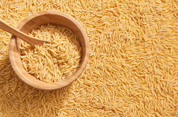 Many barley noodle and wooden plate and spoon.