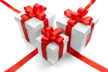 Gift boxes with red ribbon bow isolated on white background