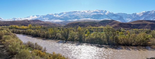 Panoramic view of a valley with snow capped mountains and River Euphrates near Erzincan, Turkey