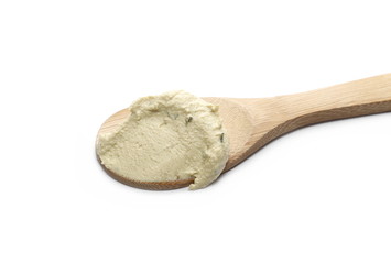 Hummus, chickpea and pumpkin seeds spread in wooden spoon, isolated on white background