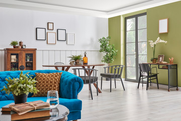 Close up sofa and middle table and dining room background. White and green wall.