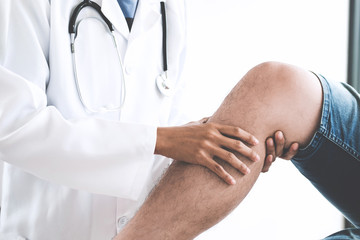 Doctor checking patient with knees to determine the cause of illness