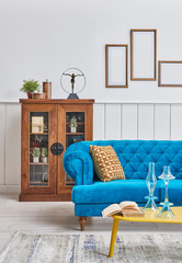 Living room blue classic sofa yellow middle table and yellow pillow. Wooden cabinet and retro style...