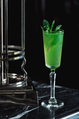 Green refreshing Alcoholic Cocktail. Mint on top