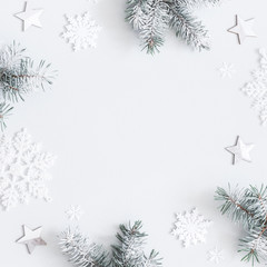 Christmas composition. Frame made of fir tree branches, decorations on pastel gray background. Christmas, winter, new year concept. Flat lay, top view, copy space, square