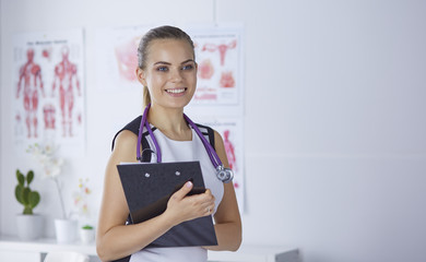 A young female doctor at a desk in the office. The concept of health and medicine