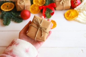 Christmas gift box, food decor and fir tree branch on wooden table. Top view with copy space
