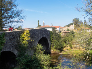 Fototapeta na wymiar Medieval stone bridge Ponte Velha over the Furelos River - Furelos