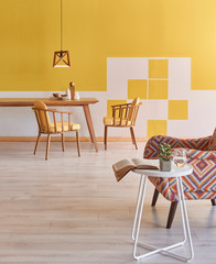 Modern yellow room, wooden furniture with close up armchair and coffee table.