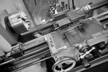 Lathe machine for metal cutting, machinery center background.