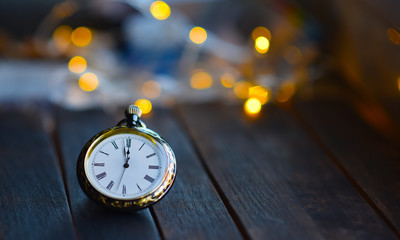 clock on the background of Christmas garlands
