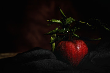 Raw Red apple on dark table