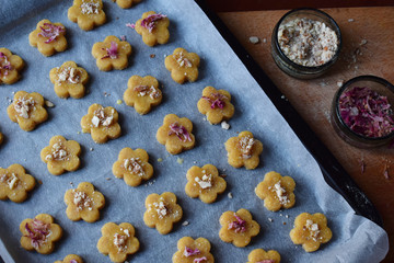 Making chickpea cookies pastries with almonds and tea rose petals. Traditional Eastern sweets. Gluten free. Grain free. Paleo diet. Healthy food. Step 4. Sprinkle cookies with nuts and rose petals.