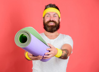 Man bearded athlete hold fitness mat red background. Athlete coach ready for training. Old school aerobics concept. Join my stretching program. Stretching and pilates concept. Athlete sport coach