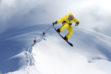 Skiers climbing a snowy mountain