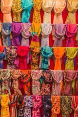 Fototapeta na wymiar Colorful scarfs on display on racks in a bazaar.