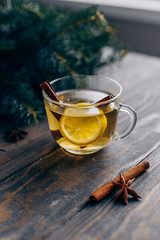 Tea with lemon and cinnamon on a wooden table