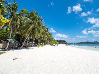 View of tropical beach on the island Malcapuya, Busuanga, Palawan, Philippines. Beautiful tropical island with sand beach, palm trees. Travel concept. November, 2018