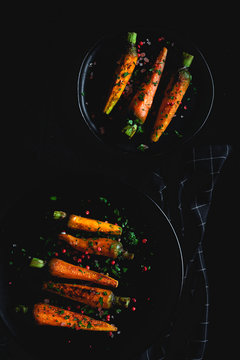Healthy roasted carrots On dark background