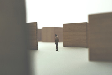 man walking in a complex maze looking for exit