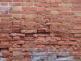 Exposed brick wall on village road