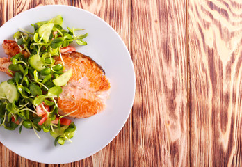 Salmon and salad on plate