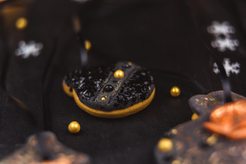 Hand painted Christmas gingerbread on a black background. Close-up.