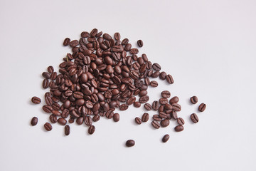 Many coffee beans on the white table.