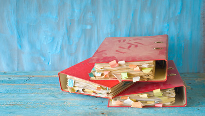 Heap of messy, old dusty file folders and documents, red tape, bureaucracy concept