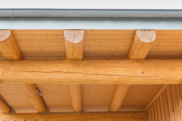 New wooden roof construction with tree trunks