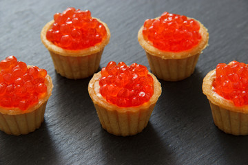 Tartlets with red caviar. Selective focus, space for text . serve red caviar