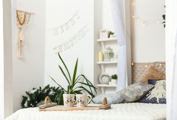 White cozy bed and Christmas lights