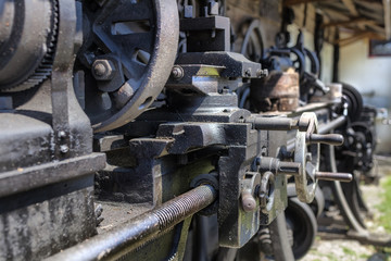 Fototapeta na wymiar Details on an old lathe engine in Cernat village, Transylvania, Romania. Old machines, old utensils. Hdr image