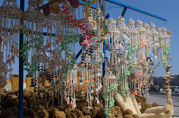 Mediterranean wind chimes out of sea shells on the background of blue sky