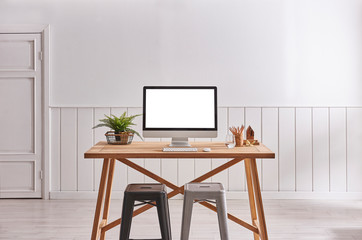 Desktop on the table. White screen. White background. Working room interior.