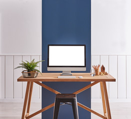 Close up desktop on the wooden table. White and blue background and black chair.