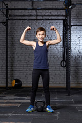 Training and sport. Kid in crossfit gym. Healthy lifestyle.