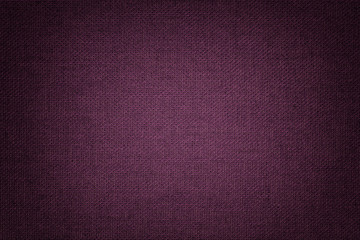 Dark purple background from a textile material with wicker pattern, closeup.